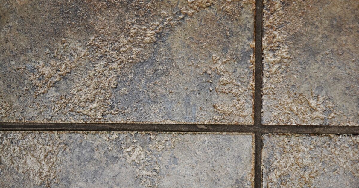 Yellowed grout lines between bathroom tiles