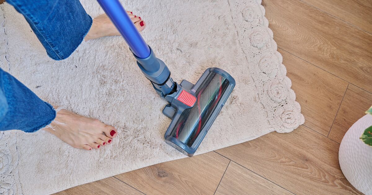 Vacuum next to worn carpet area