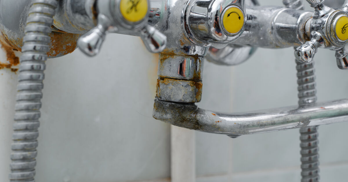 White limescale around faucet spout