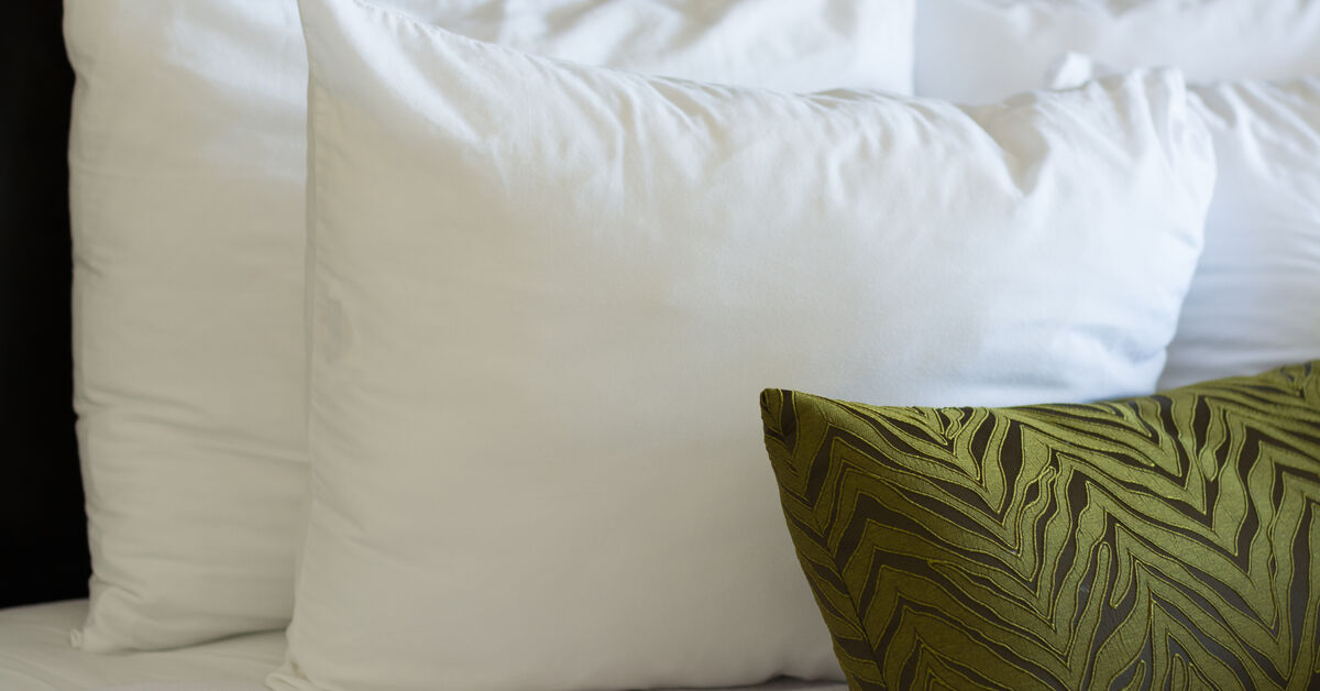 Clean bed with white pillows