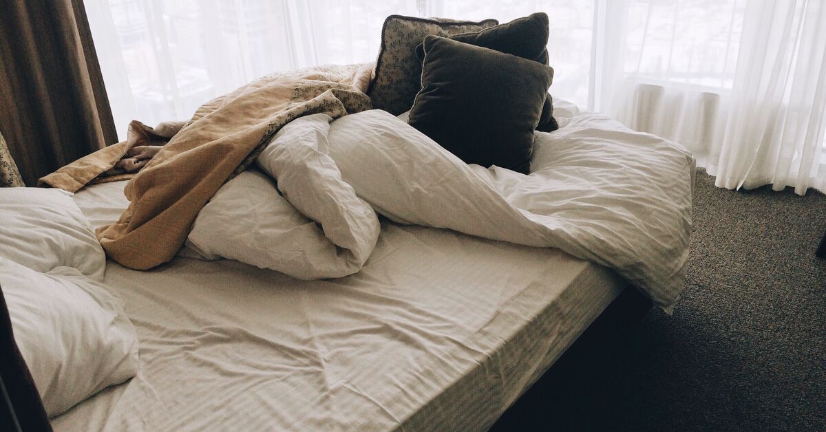Unmade bed in bedroom